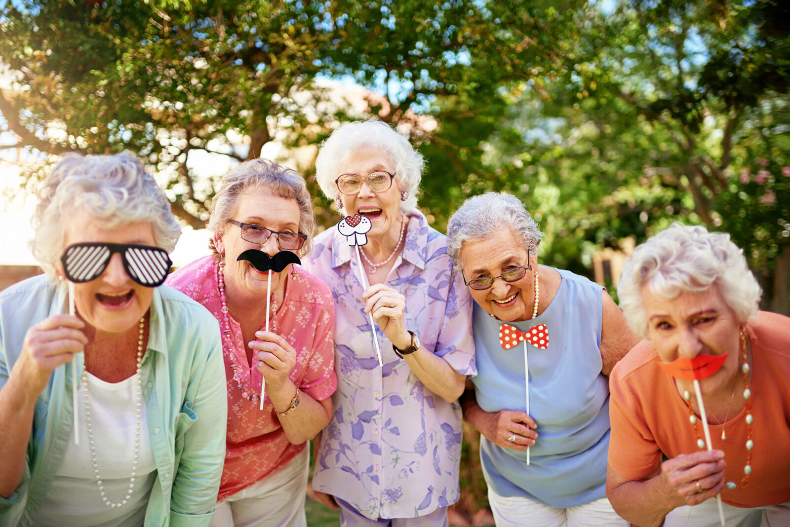 Cropped portrait of a group of quirky senior friends messing around outdoors